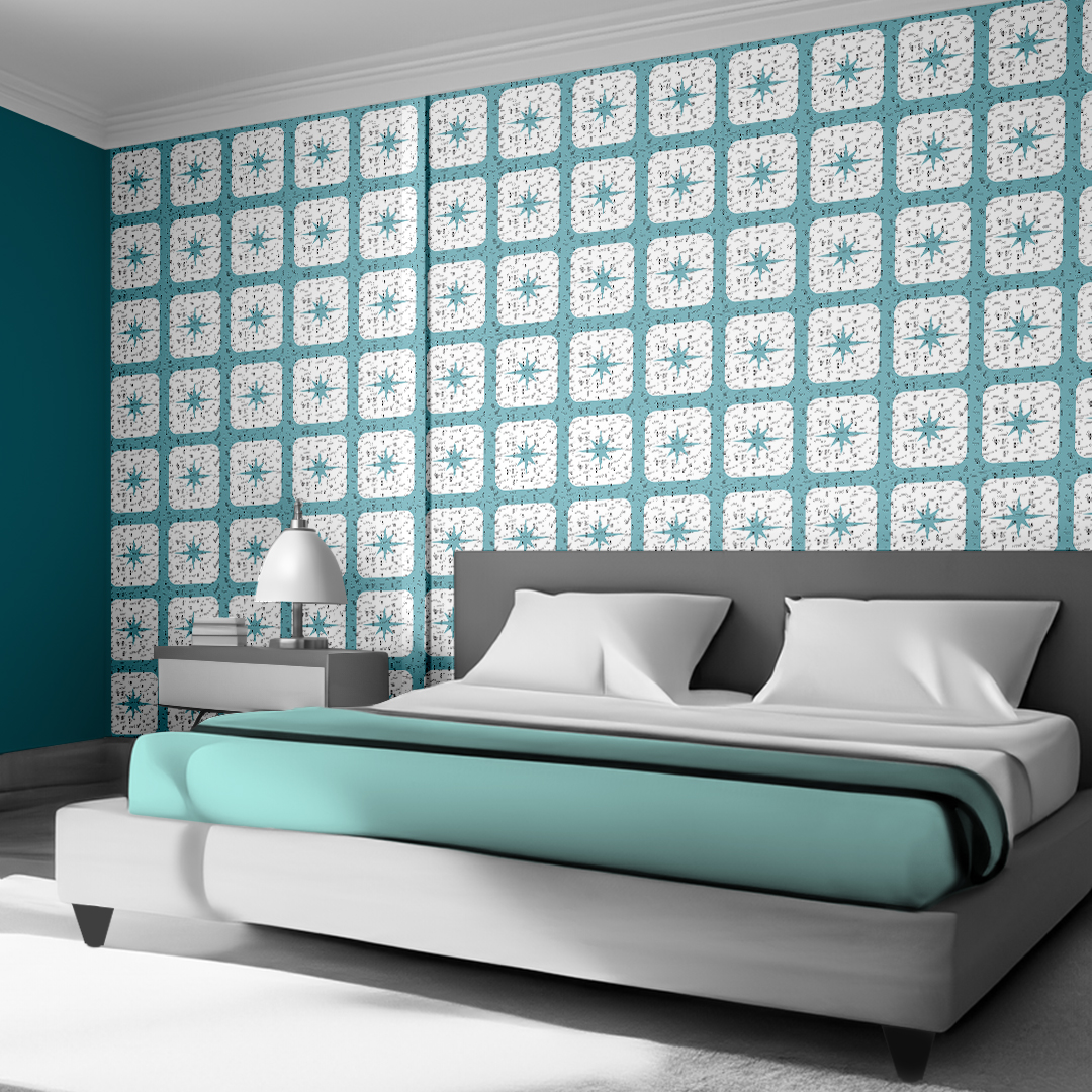 The artwork features a repeating geometric pattern of symmetrical shapes resembling elongated, curved diamonds or petals in various shades of blue and green. Each shape is split vertically with one half filled with a light blue and the other half filled with green or darker blue. The background is a light, almost pastel blue, which provides a soft yet vibrant backdrop. One of the blue shapes near the upper left contains a white starburst element, adding a focal point of brightness to the composition. The overall design conveys a modern, mid-century aesthetic with clean lines and harmonious color contrasts.